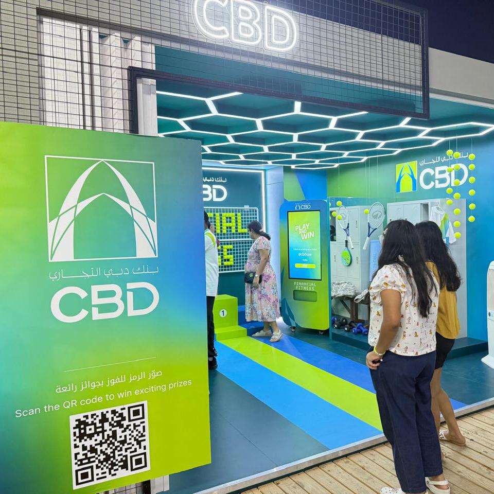 Interactive multi-level touch screen game rental at Dubai 30x30 event, showing guests engaged in a gamified fitness and financial literacy challenge.