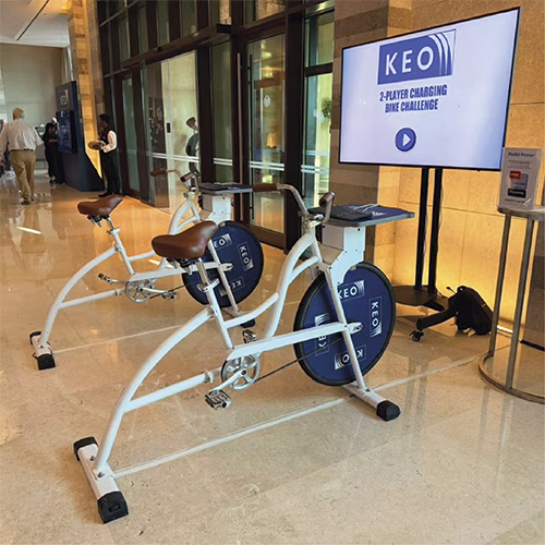 Guests racing on interactive bike game at corporate event in Dubai