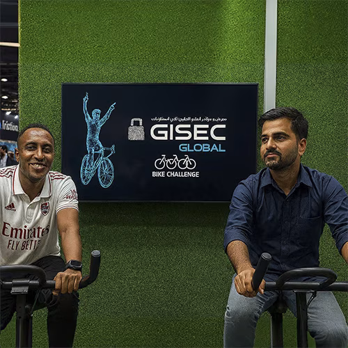Guests racing on interactive bike game at corporate event in Dubai