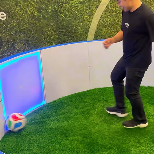 Custom-branded Interactive Football Arena setup at a Dubai exhibition venue with an electronic leaderboard for competition
