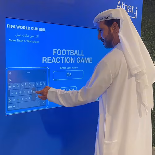 Custom-branded Interactive Football Arena setup at a Dubai exhibition venue with an electronic leaderboard for competition