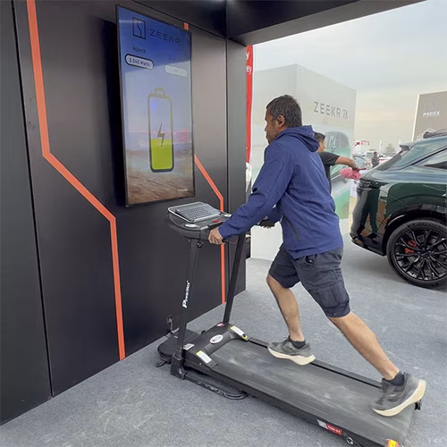 Interactive Treadmill Activation in Dubai: Participants generating human power to recharge EV cars