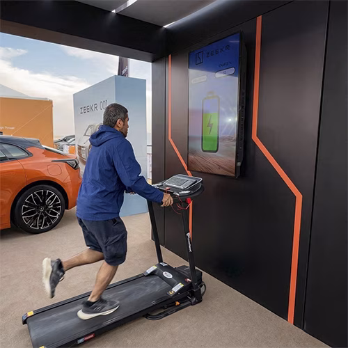 Interactive Treadmill Activation in Dubai: Participants generating human power to recharge EV cars