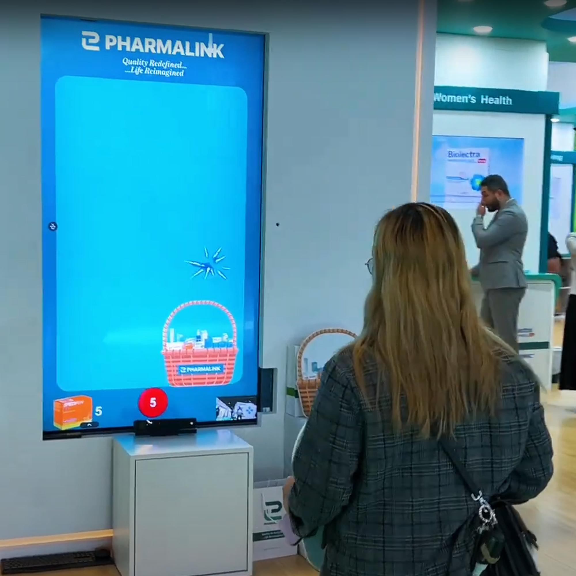 Player using body to slash branded items in a motion sensor game at exhibition in Dubai