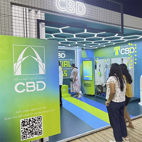 Interactive multi-level touch screen game rental at Dubai 30x30 event, showing guests engaged in a gamified fitness and financial literacy challenge.