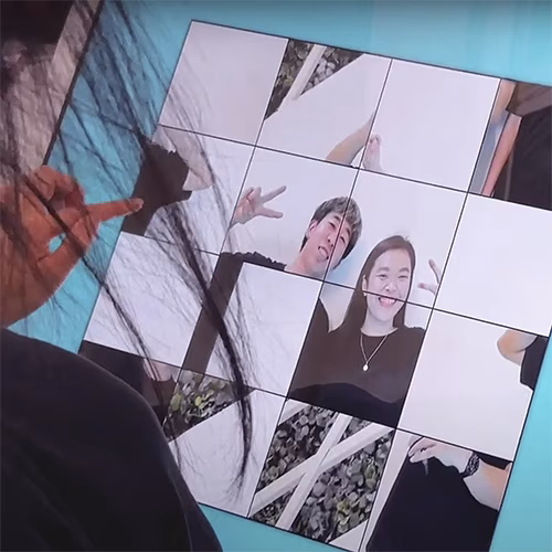 Player solving a shuffled photo puzzle of their face during an interactive event challenge.
