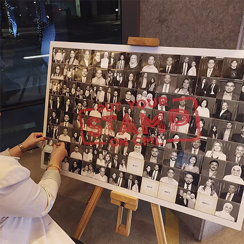 Guests adding photos to a digital mosaic wall, creating a collaborative image masterpiece at a live event.
