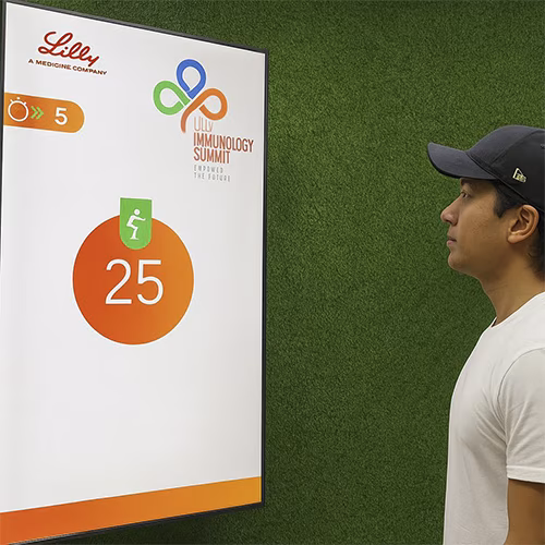 Participants enjoying the Squat Game Challenge at a corporate event in Dubai, engaging in fitness and team-building through real-time interactive squat tracking.