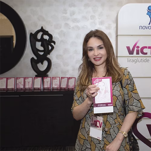 Guest using Text Selfie Photo Booth at an event in Dubai, receiving a printed word cloud image made from their photo with custom branded text for marketing activation