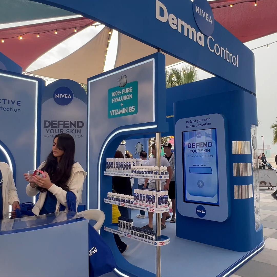 Guests playing the interactive Catch and Dodge game at a Niveae event in Dubai. Custom branded screen with data capture for exhibition marketing