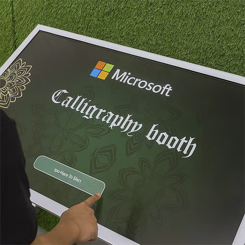 Guest receiving printed Arabic calligraphy artwork at a live event in Dubai, showcasing AI-powered personalized calligraphy in an elegant cultural setting.