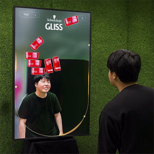 Guest playing interactive balance game using motion sensors to stack virtual items on head at a corporate event or exhibition booth in Dubai – fun and engaging activity.