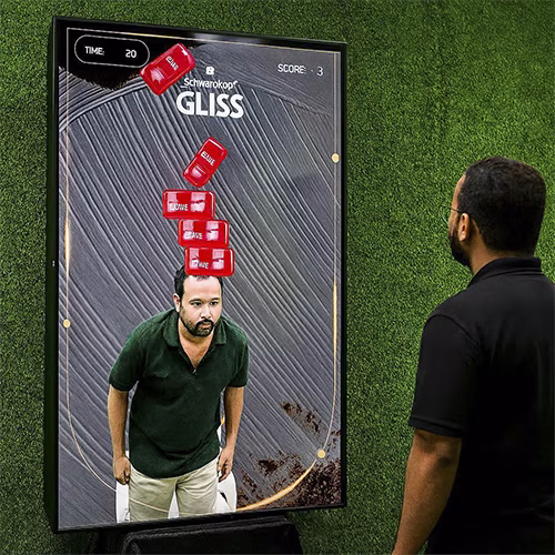 Guest playing interactive balance game using motion sensors to stack virtual items on head at a corporate event or exhibition booth in Dubai – fun and engaging activity.
