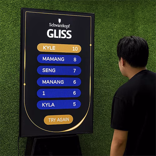 Guest playing interactive balance game using motion sensors to stack virtual items on head at a corporate event or exhibition booth in Dubai – fun and engaging activity.