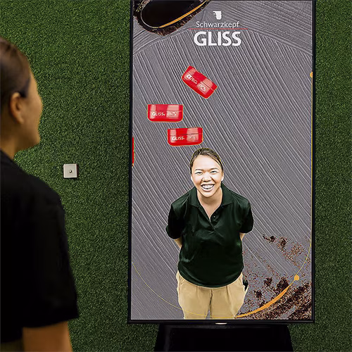 Guest playing interactive balance game using motion sensors to stack virtual items on head at a corporate event or exhibition booth in Dubai – fun and engaging activity.
