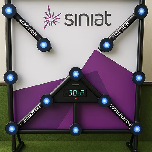 Woman playing Batak reaction game at a fitness event in Dubai, touching illuminated buttons to test her speed and reflexes. "Speedy Speedy" displayed on wall.