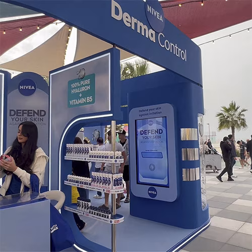 Guests playing the interactive Catch and Dodge game at a Niveae event in Dubai. Custom branded screen with data capture for exhibition marketing