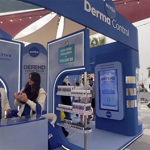 Guests playing the interactive Catch and Dodge game at a Niveae event in Dubai. Custom branded screen with data capture for exhibition marketing