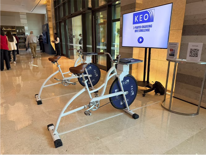 Guests racing on interactive bike game at corporate event in Dubai