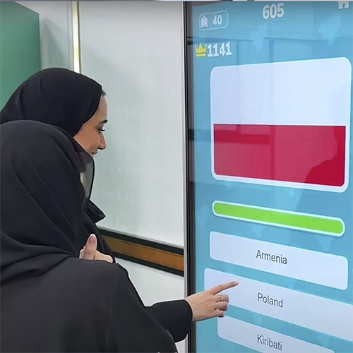 Participants playing the interactive Guess the Flag game at an event, engaging with a fun, branded quiz experience that tests geographical knowledge in a lively setting.