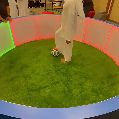 Custom-branded Interactive Football Arena setup at a Dubai exhibition venue with an electronic leaderboard for competition