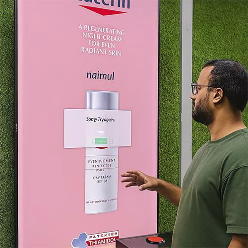 Guests playing Freeze the Frame interactive game at a corporate event in Dubai, focusing on screen visuals and pressing the button to stop the image at the perfect moment.