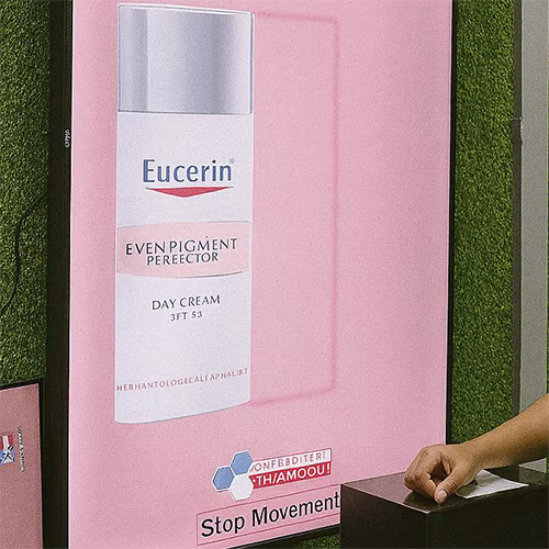 Guests playing Freeze the Frame interactive game at a corporate event in Dubai, focusing on screen visuals and pressing the button to stop the image at the perfect moment.