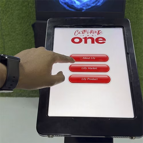 AI kiosk at an event features a digital display of a ai hologram woman in a blue hijab