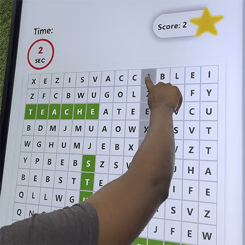 Guest playing interactive word search game at corporate event in Dubai, with branded screen, vibrant green backdrop