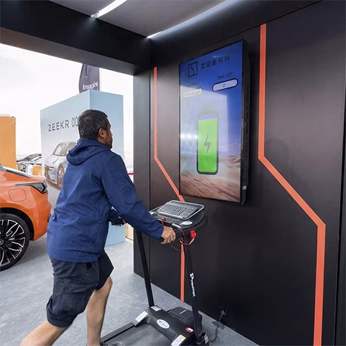 Interactive Treadmill Activation in Dubai: Participants generating human power to recharge EV cars