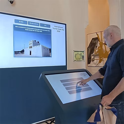 Multi-screen interactive UAE landmark guessing game display with custom branded interface for immersive event activation and digital tourism engagement.
