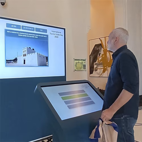 Multi-screen interactive UAE landmark guessing game display with custom branded interface for immersive event activation and digital tourism engagement.