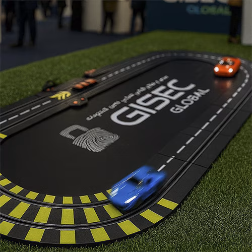 Guest wearing brainwave headband racing a slot car using mind control at a Dubai tech event. Interactive, hands-free game rental for events and exhibitions