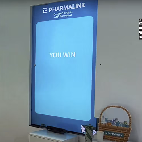 Player using body to slash branded items in a motion sensor game at exhibition in Dubai