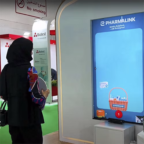 Player using body to slash branded items in a motion sensor game at exhibition in Dubai