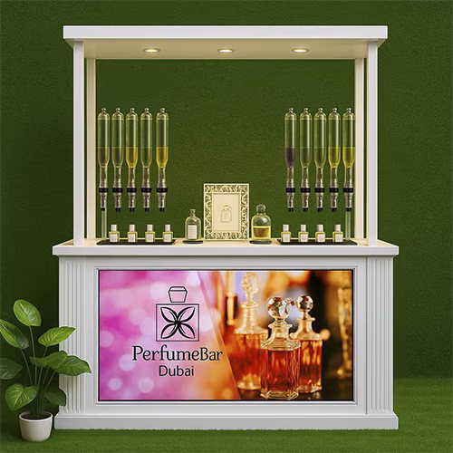 Perfume Booth setup in Dubai featuring a branded fragrance bar with colorful dispensers, interactive screen, and artificial grass backdrop for events and exhibitions