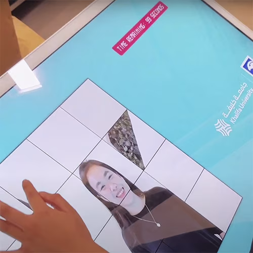 Player solving a shuffled photo puzzle of their face during an interactive event challenge.