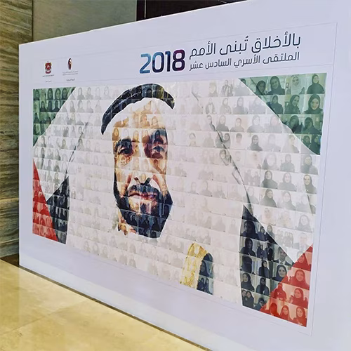 Guests adding photos to a digital mosaic wall, creating a collaborative image masterpiece at a live event.