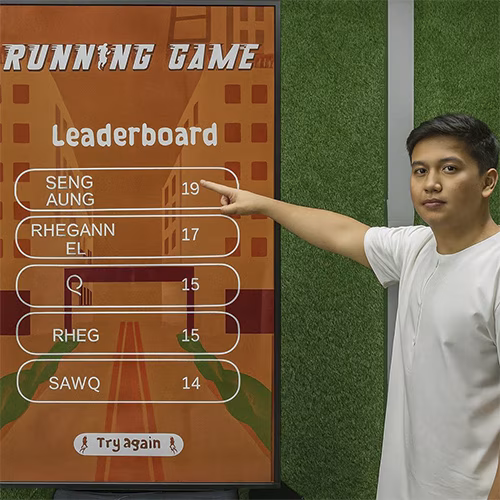 Player enjoying a motion runner game in Dubai, using full-body movement to jump and dodge obstacles. Interactive game rental