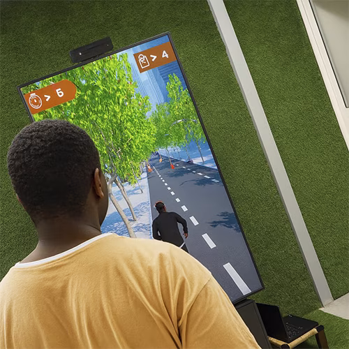 Player enjoying a motion runner game in Dubai, using full-body movement to jump and dodge obstacles. Interactive game rental