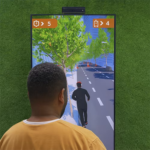 Player enjoying a motion runner game in Dubai, using full-body movement to jump and dodge obstacles. Interactive game rental