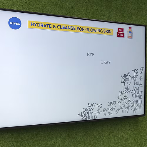 Arab woman using Sayit AI at a Dubai corporate event, speaking into a mic as 3D branded text appears on a large screen, showcasing interactive event technology rental
