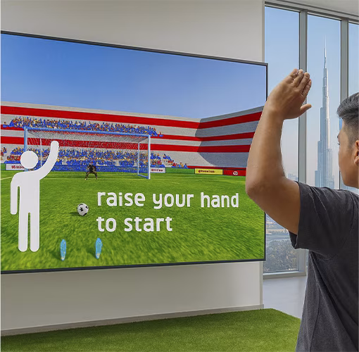 Guests playing a digital soccer penalty shootout game at an event, featuring real-time scoring, interactive gameplay, and customizable branding in the UAE