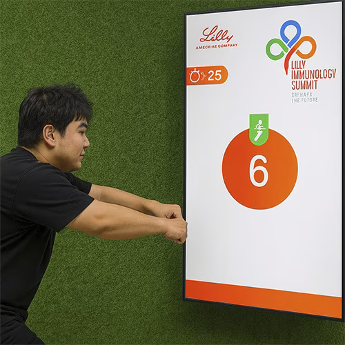 Participants enjoying the Squat Game Challenge at a corporate event in Dubai, engaging in fitness and team-building through real-time interactive squat tracking.