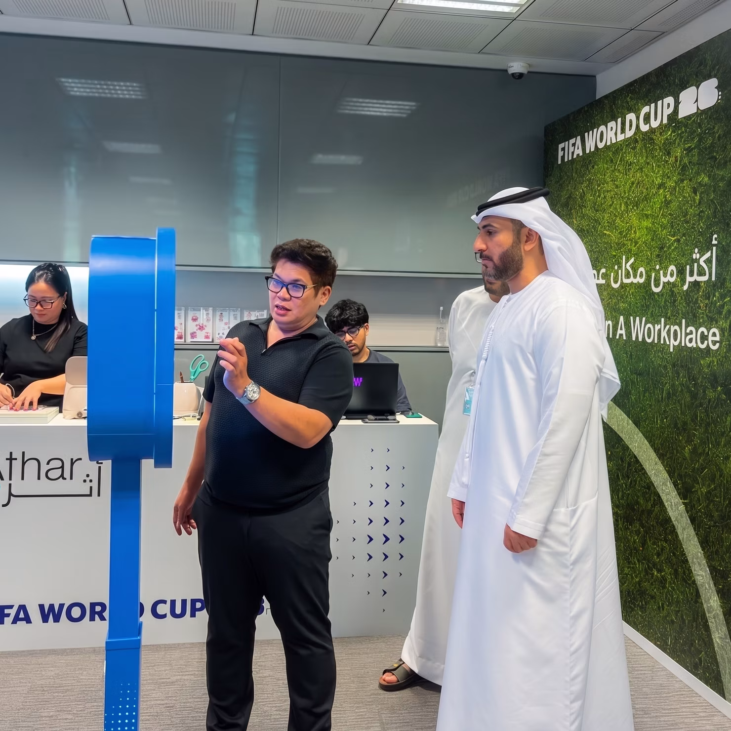 Guest holding a custom-printed sheet of branded AI branded stickers at a Dubai corporate event