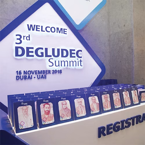 Guest using Text Selfie Photo Booth at an event in Dubai, receiving a printed word cloud image made from their photo with custom branded text for marketing activation